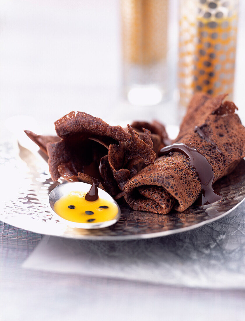 Bitter chocolate pancakes with passionfruit coulis