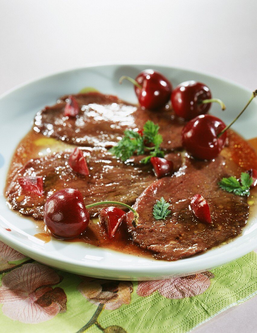 Thinly sliced duck with cherries
