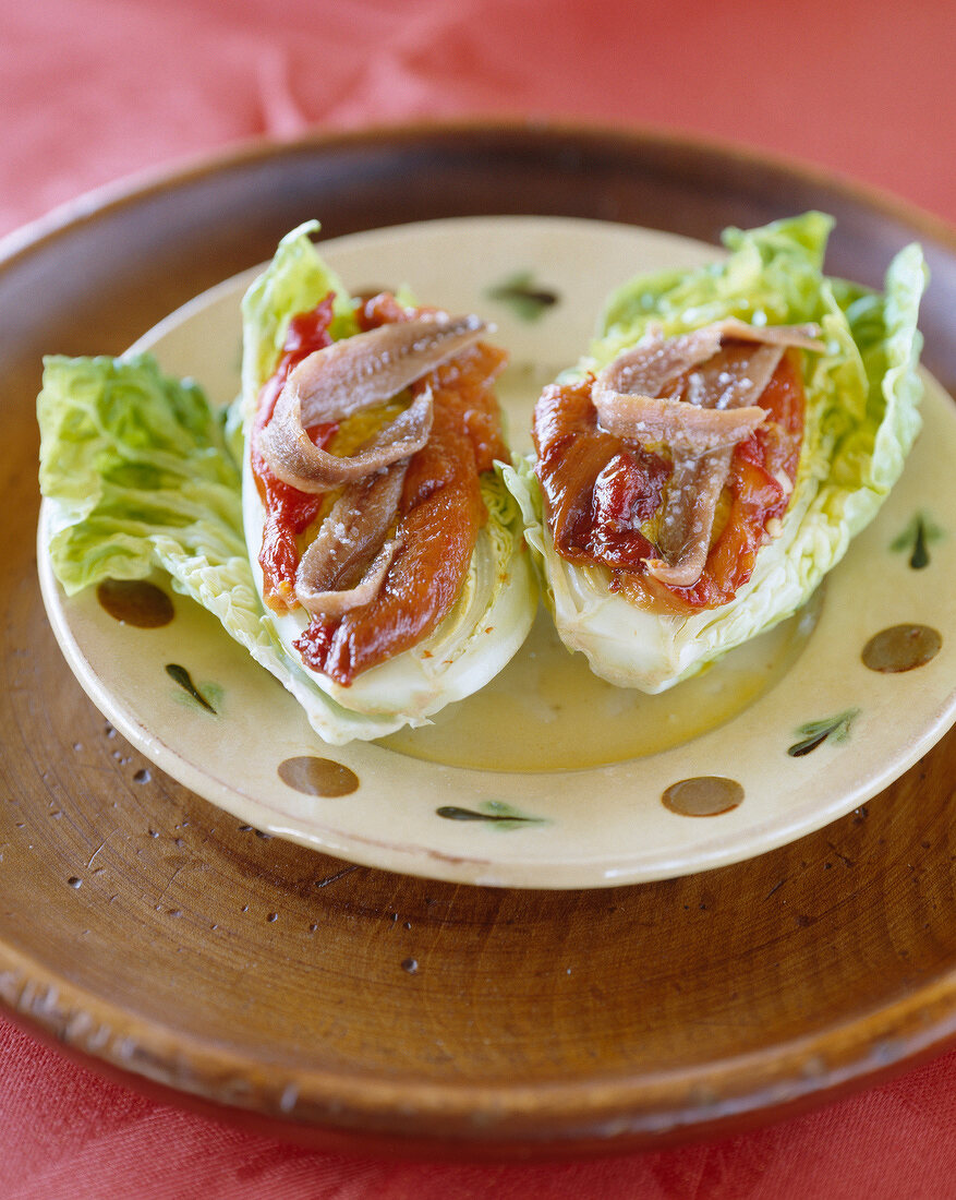 Lettuce heart with marinated peppers and anchovies