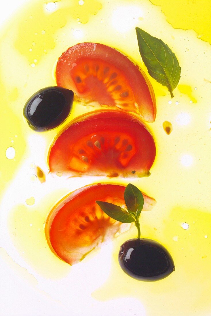 Tomatenscheiben und Oliven in Öl
