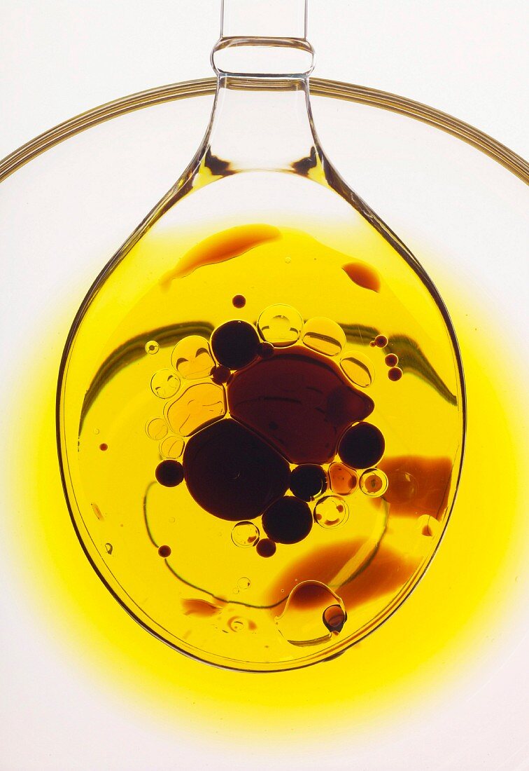 Spoonful of oil with drops of balsamic vinaigar