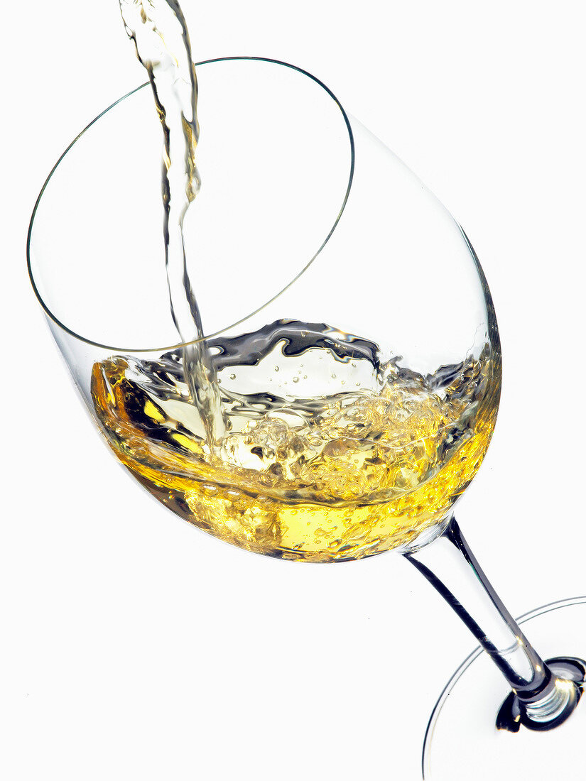 Pouring white wine into a glass