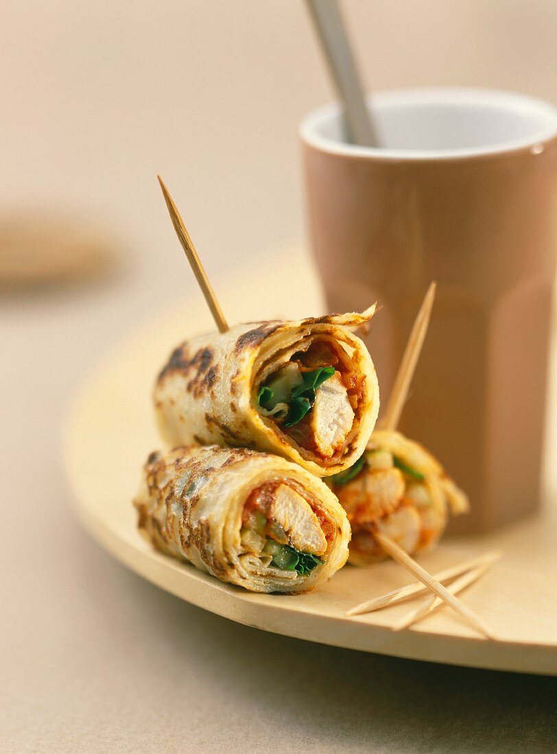 Curried sliced chicken in rolled coconut milk pancakes