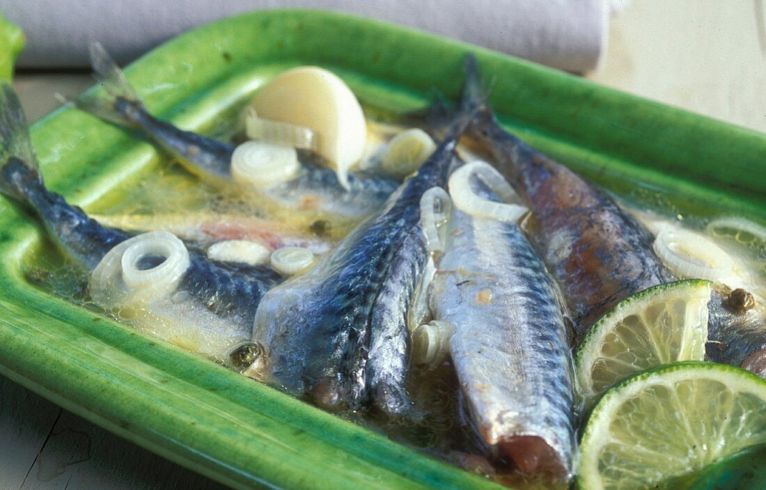 Mackerel in a white wine broth with onions, lemons, garlic and pepper