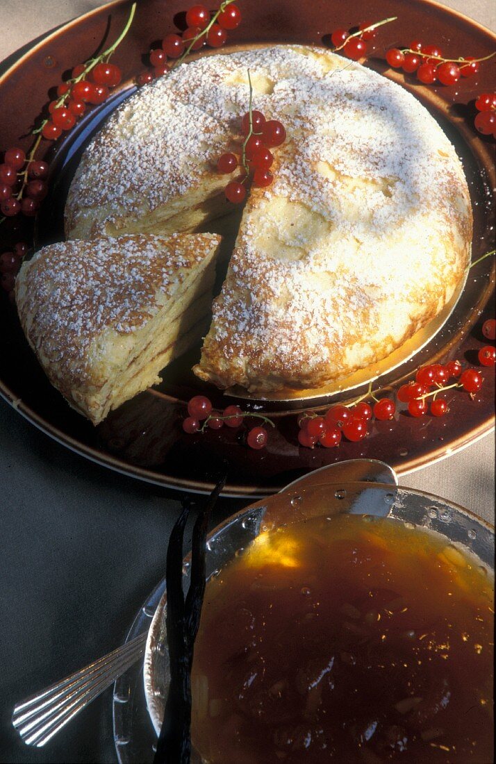 A pancake cake with apple sauce and icing sugar