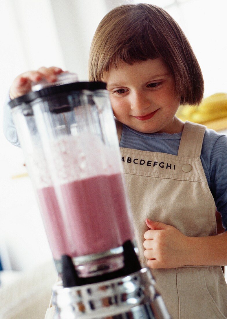 A little girl with a blender
