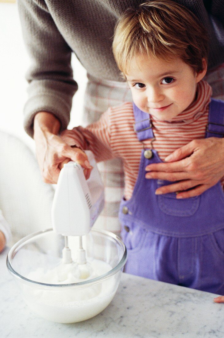 A mother and child beating egg whites