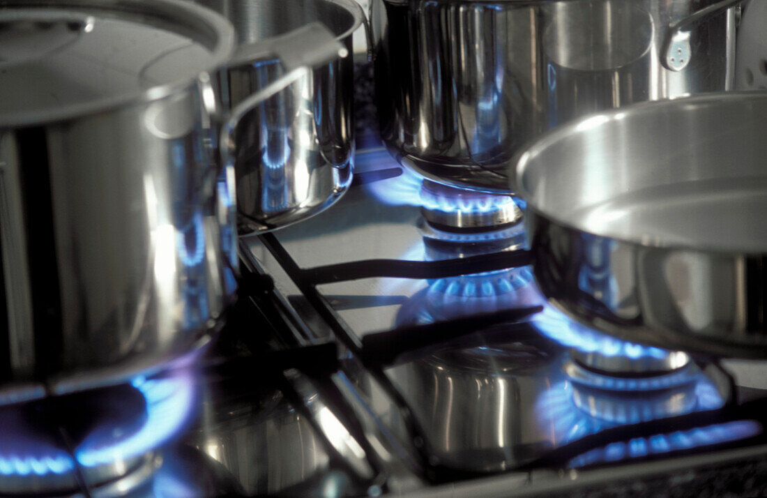 Gas stove with pans and blue flames