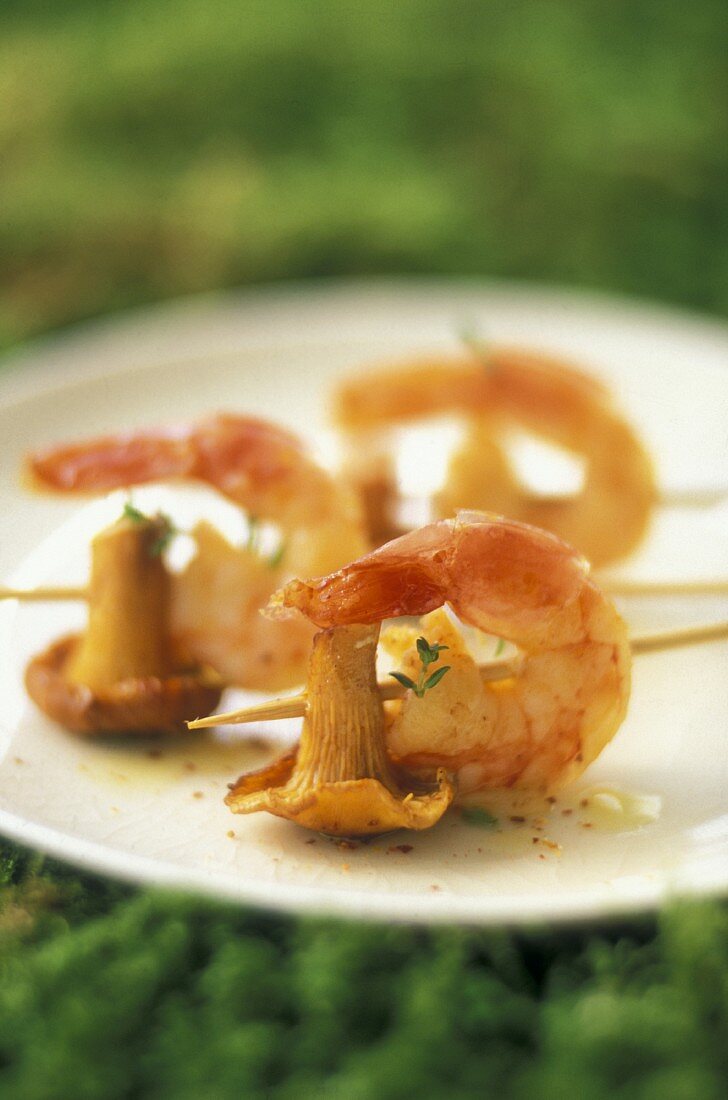 Chanterelle and pink prawn skewers