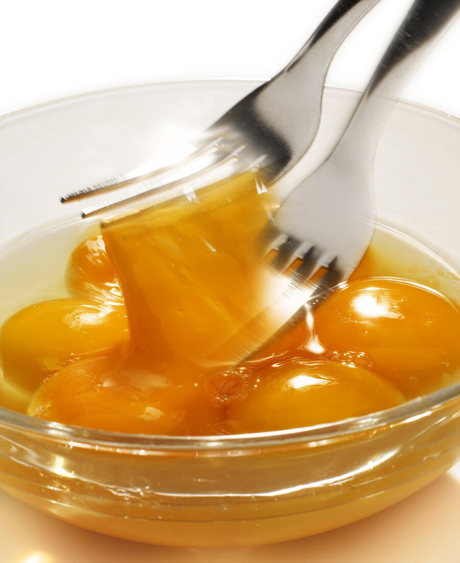 Beating egg yolks in a bowl