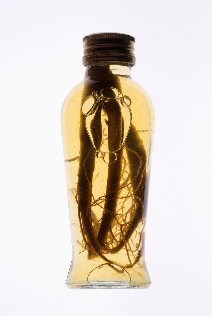Bottle of ginseng with root