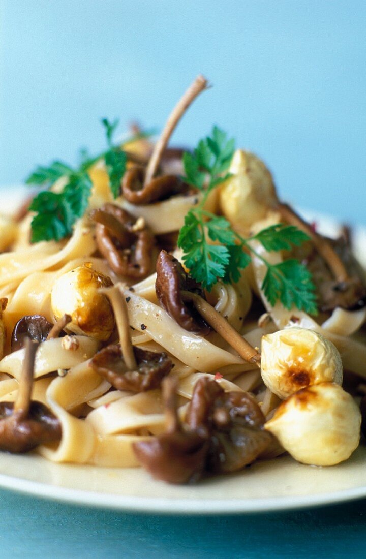 Tagliatelle with garlic parachute mushrooms and hazelnuts