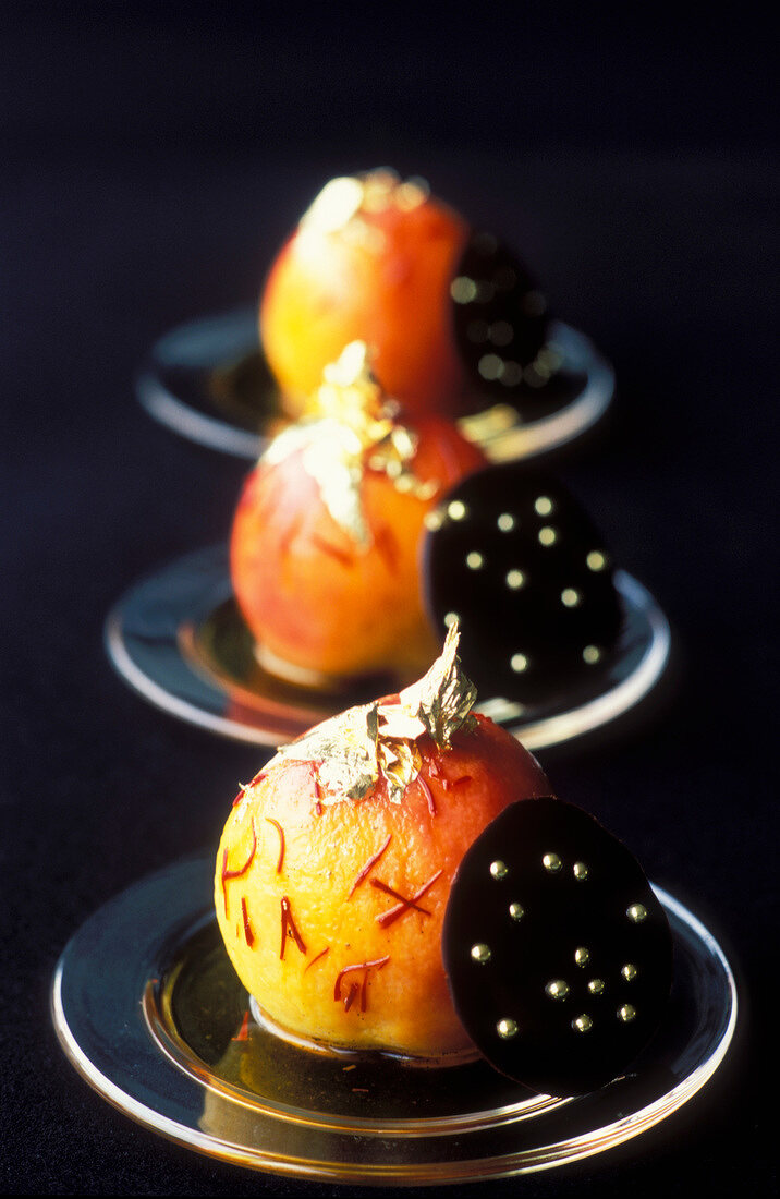 Saffron poached pears with round chocolate wafers