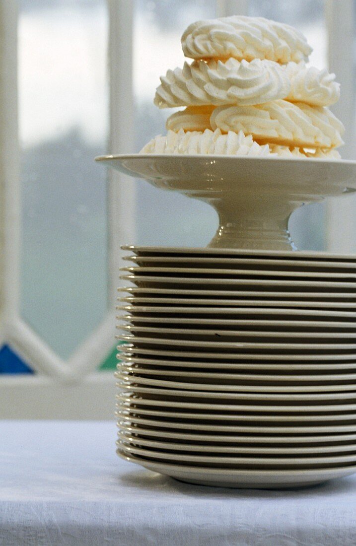 Meringues on a tall stack of plates