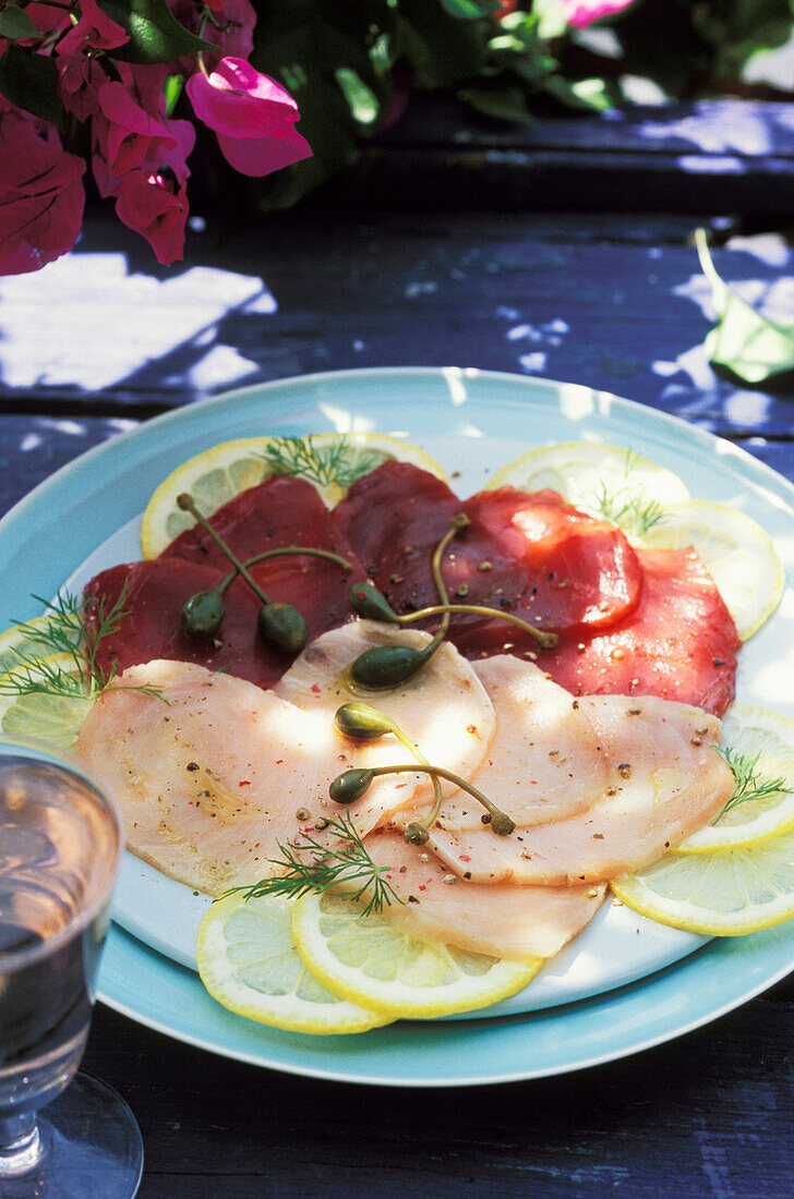 Red and white tuna carpaccio with lemon and capers