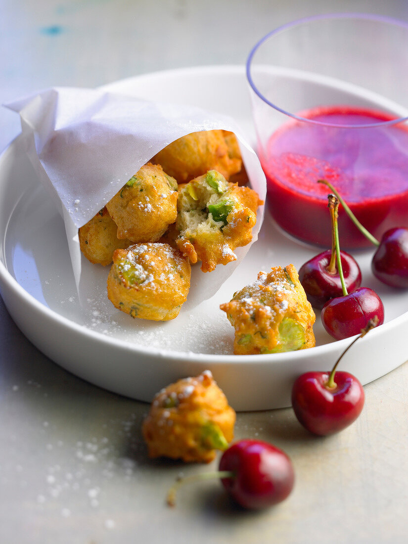 Ricotta and broad bean fritters with cherry coulis