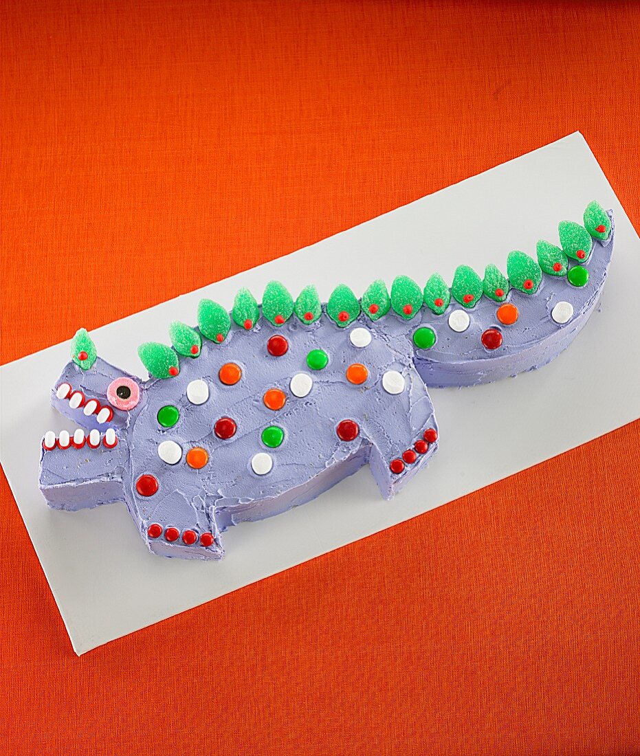 A dinosaur cake decorated with sweets