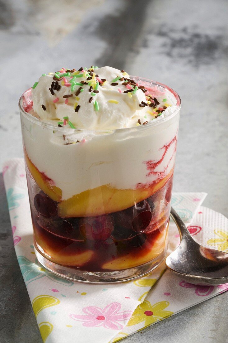 Verrine of summer fruit and peaches with whipped cream