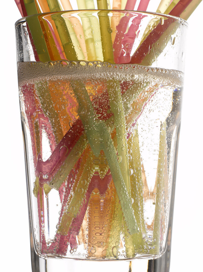 Different coloured straws in a glass of lemonade