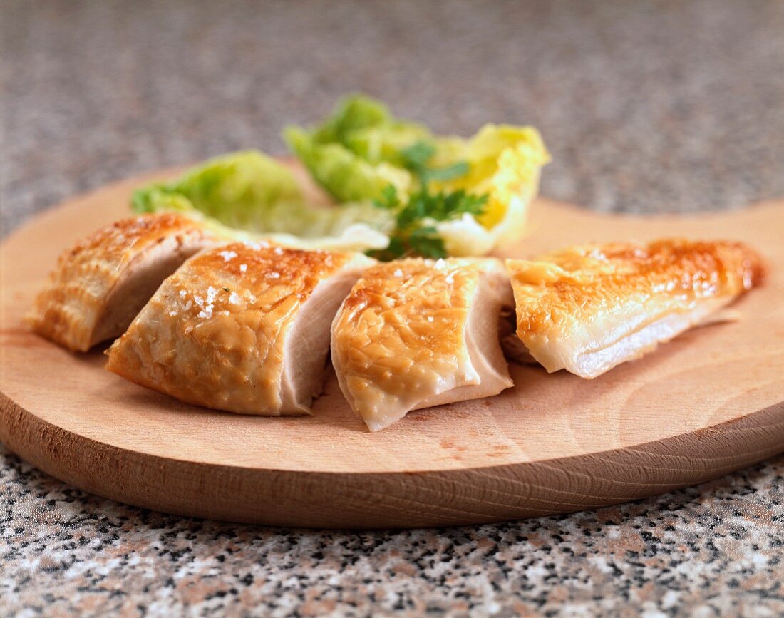 Sliced chicken breast on a chopping board