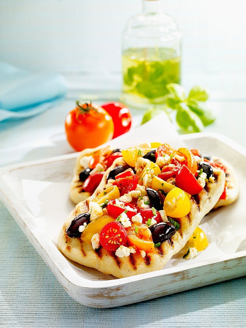 Pizza with feta cheese, olives and two types of tomatoes