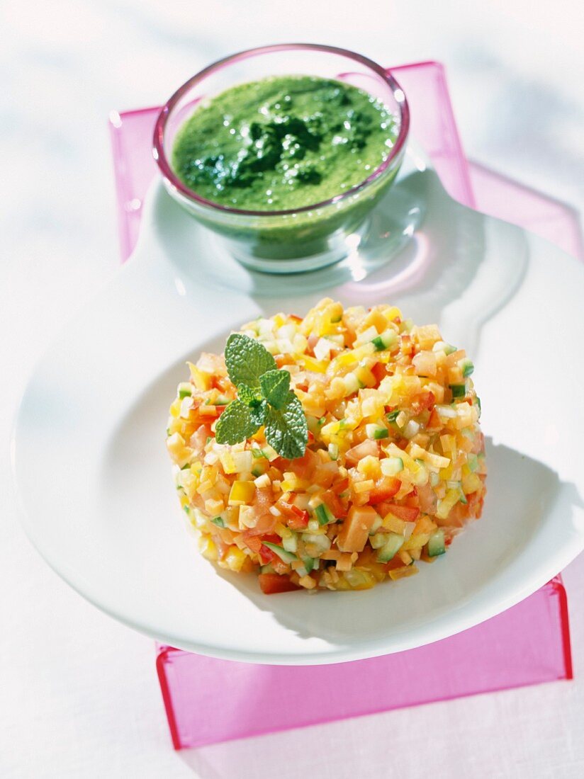 Timbale made from diced tomatoes, peppers, cucumber, carrots and onions served with a mint sauce