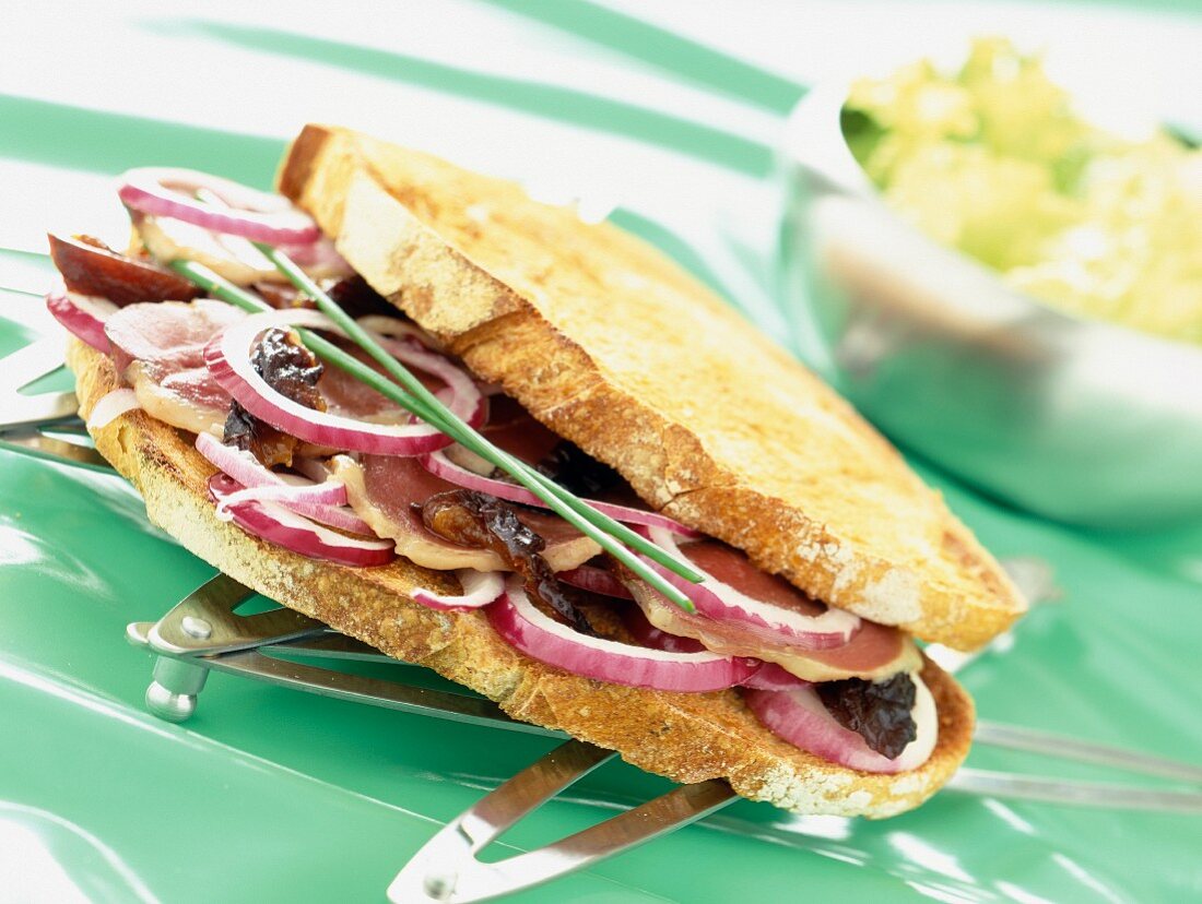 A sandwich from south-west France with smoked duck breast, dried plums and red onions