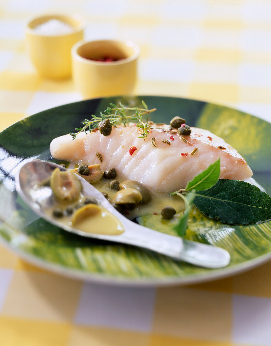 Steam-cooked piece of cod with aromatic herbs