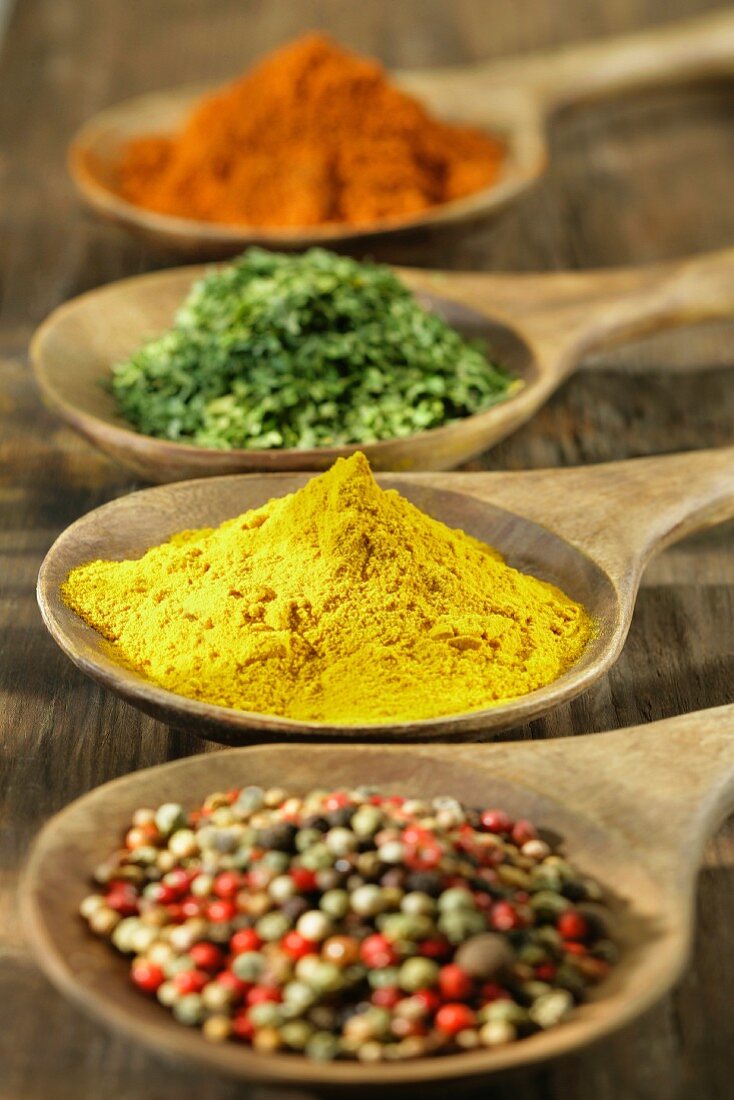 Selection of spices in wooden spoons