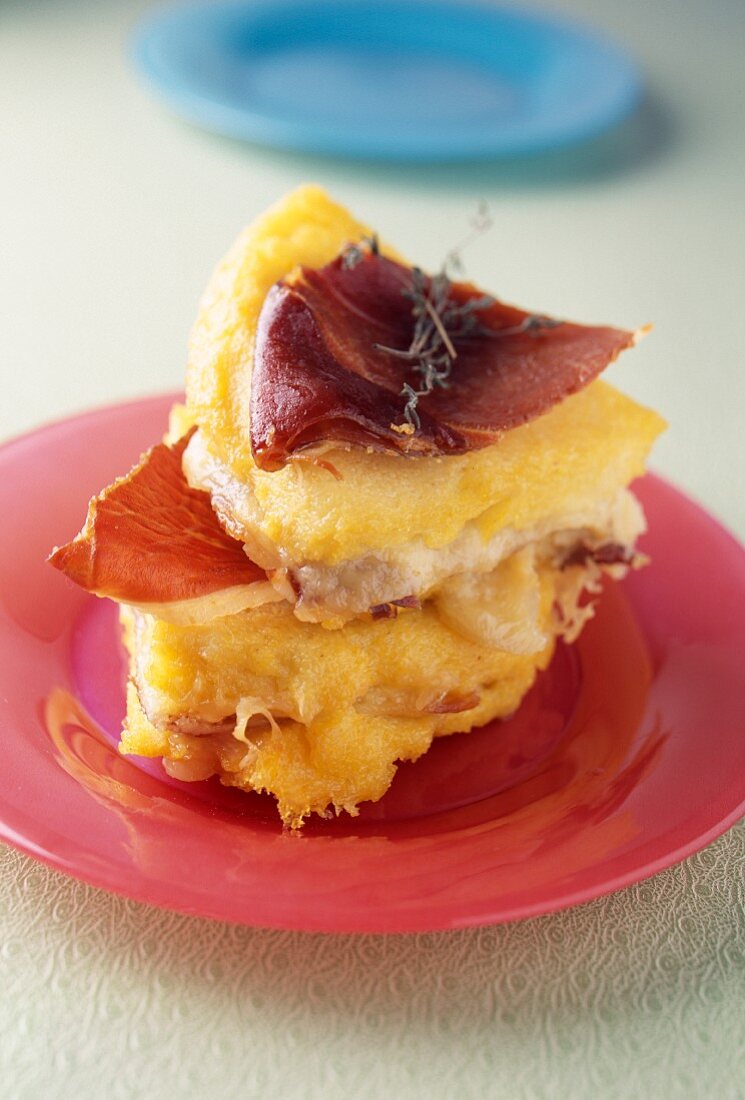 Polenta savoury cake with two cheeses and oven-baked raw ham