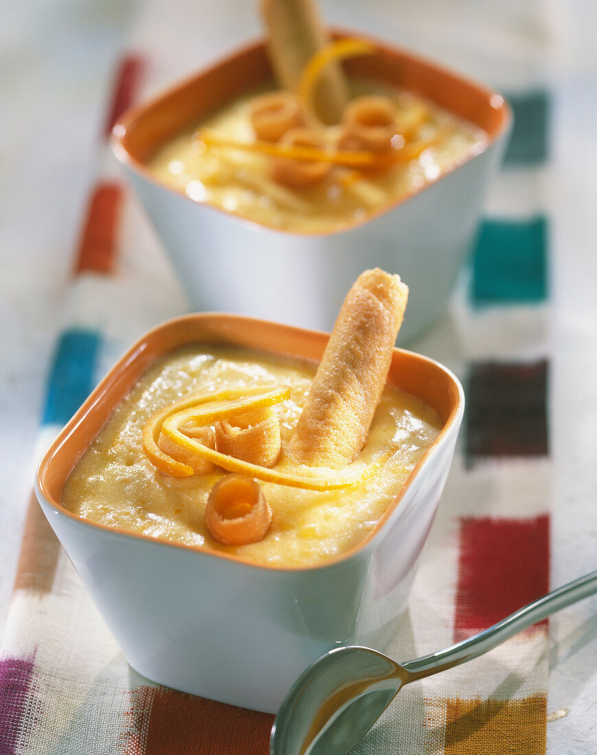 Orange cream dessert with Cigarette Russe rolled biscuits