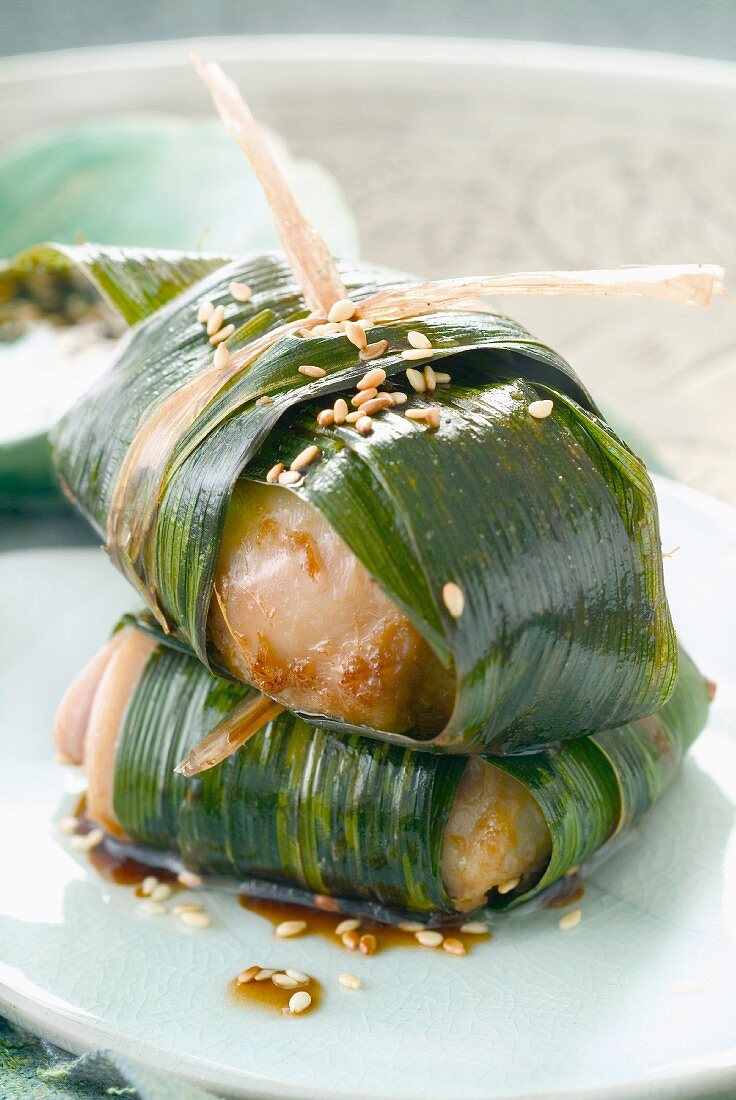 Chicken with sesame seeds wrapped in banana leaves