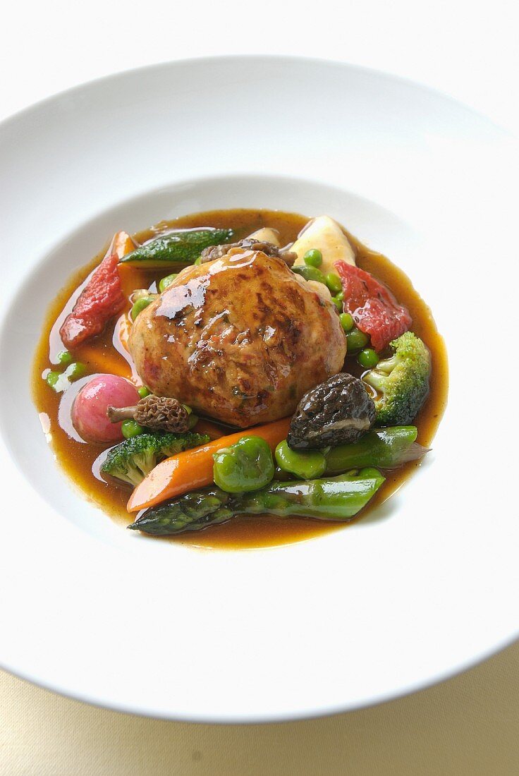 Stuffed veal Caillette with gravy and spring vegetables
