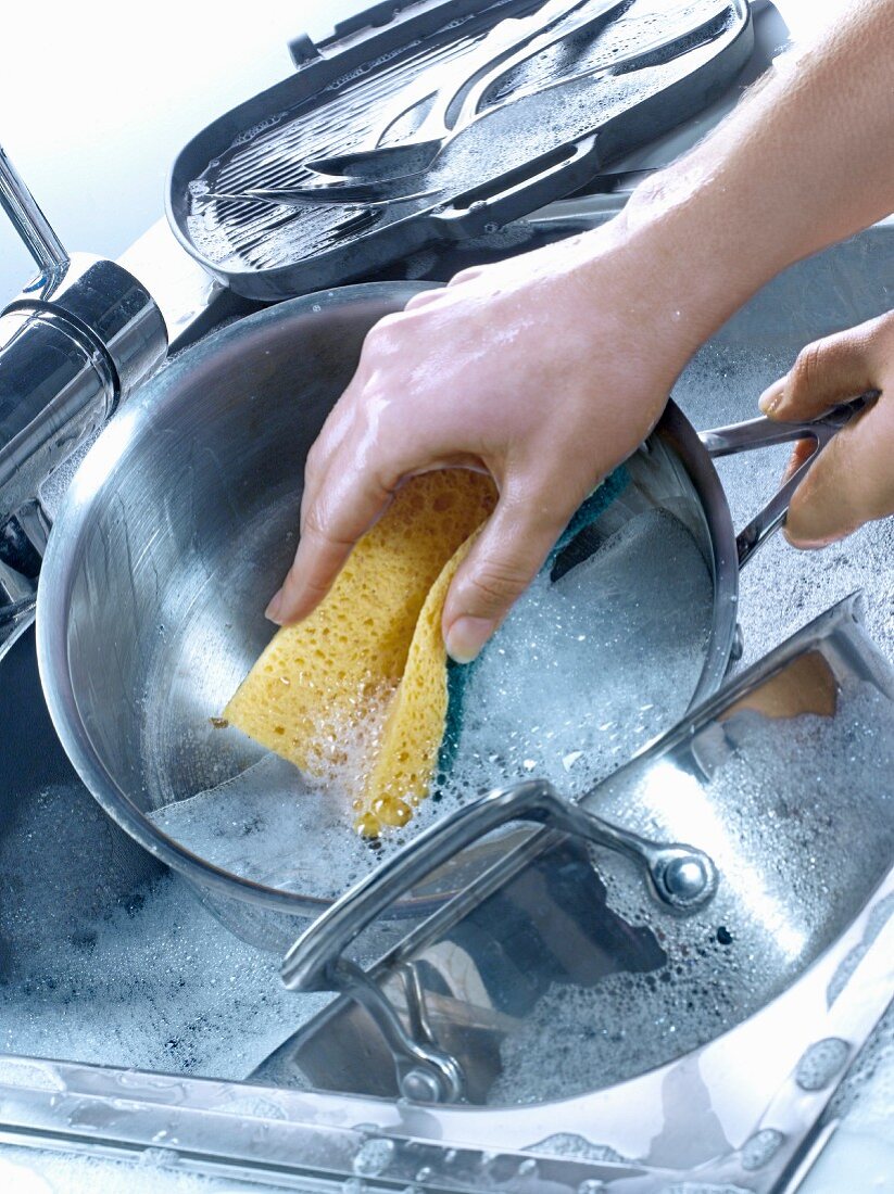 Washing the dishes in the sink