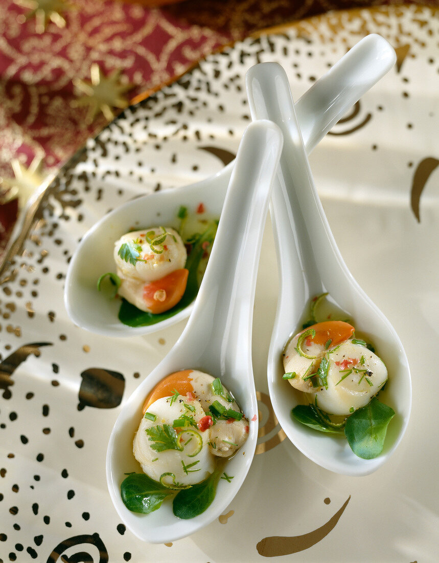 Spoonsful of marinated scallops with herbs and lime