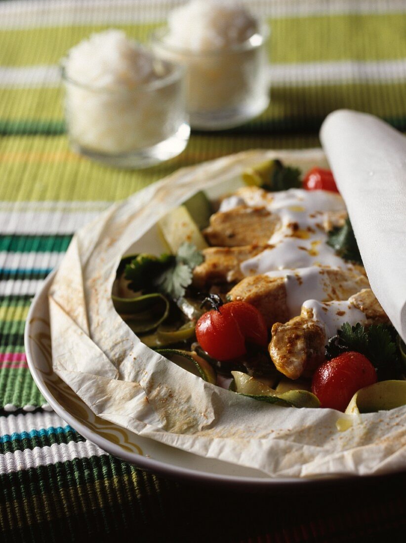 Chicken with coconut milk on parchment paper