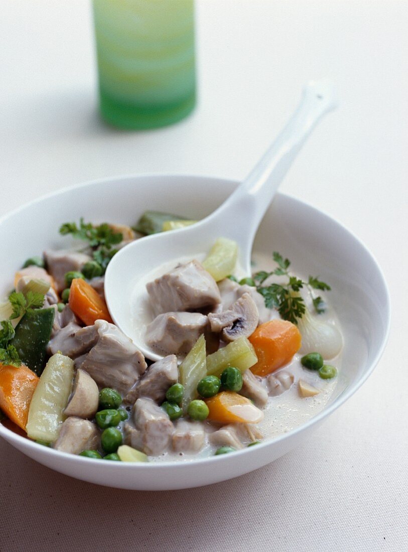 Blanquette de veau (veal fricassee, France) with young vegetables