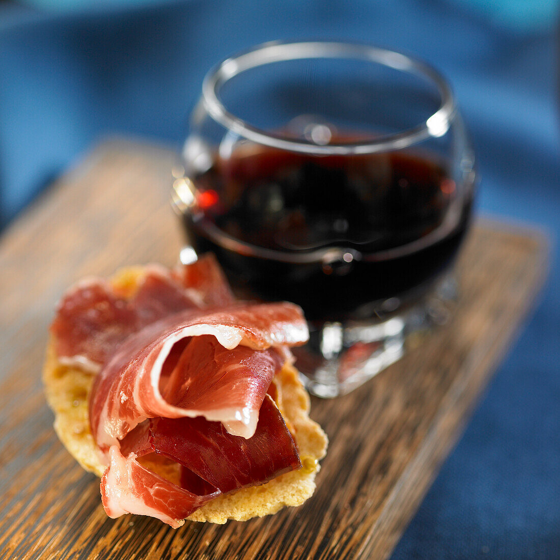 Iberian ham slices and glass of red wine