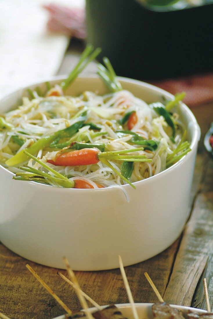 Rice noodles and vegetables cooked in a wok