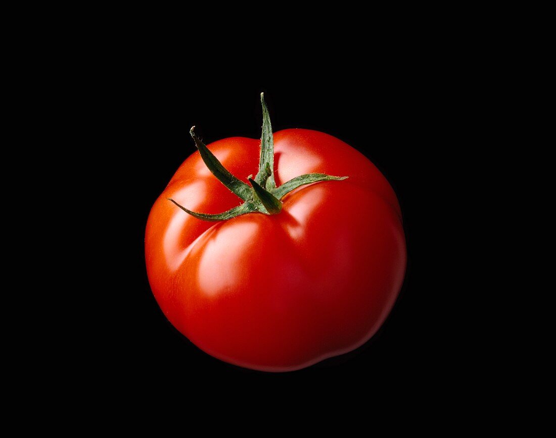 Tomato on black background