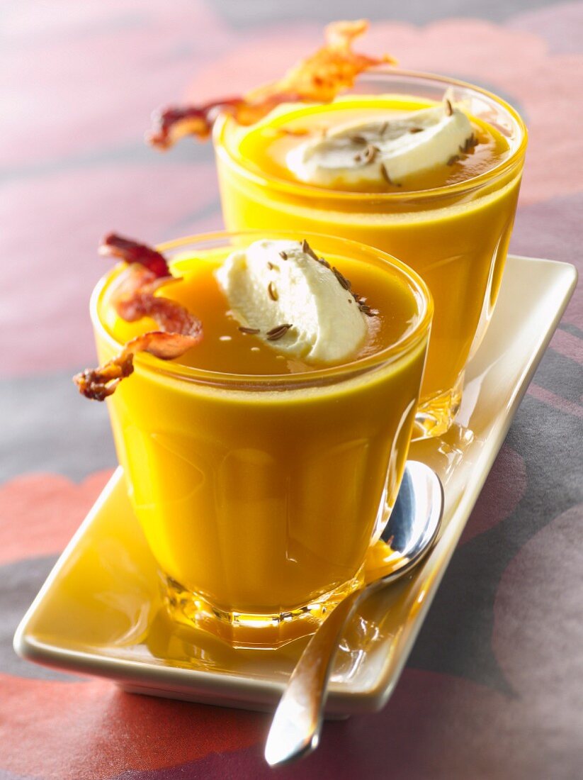 Cream of pumpkin soup with grilled bacon and salted whipped cream