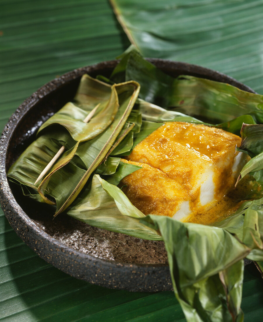 Scorpion fish fillets cooked in a banana leaf