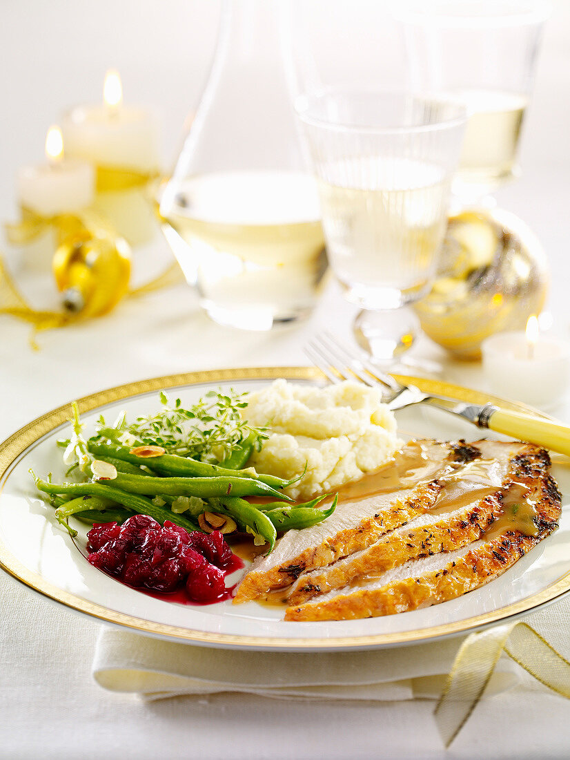 Slices of roast chicken breast,green beans,beetroot and mashed potatoes