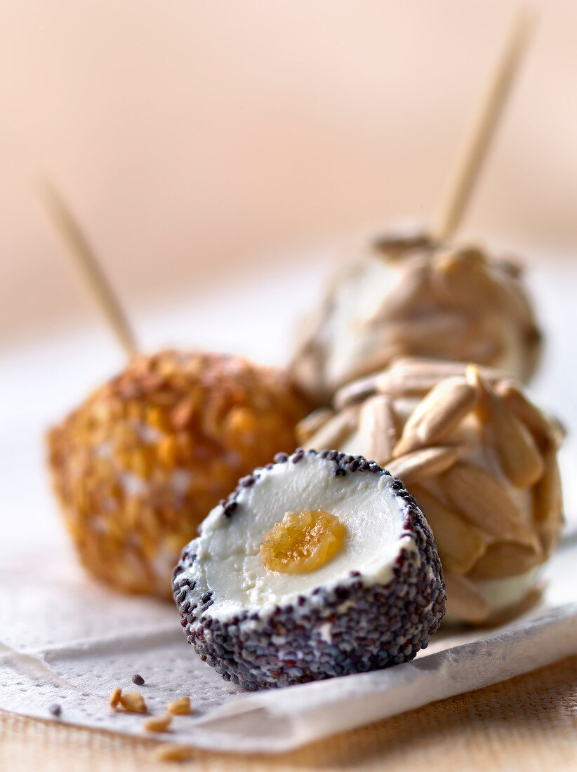 Organic goat's cheese balls coated with different seeds