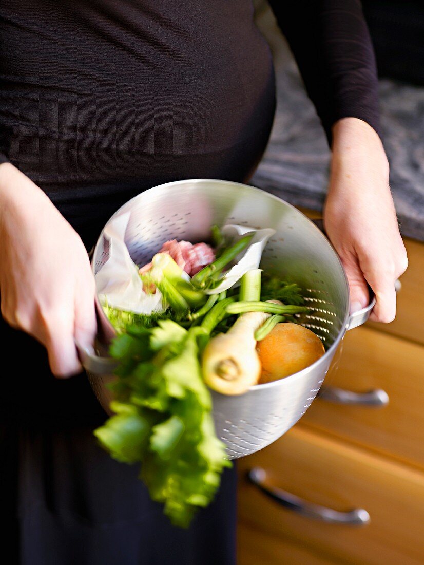 Woman straining vegetables