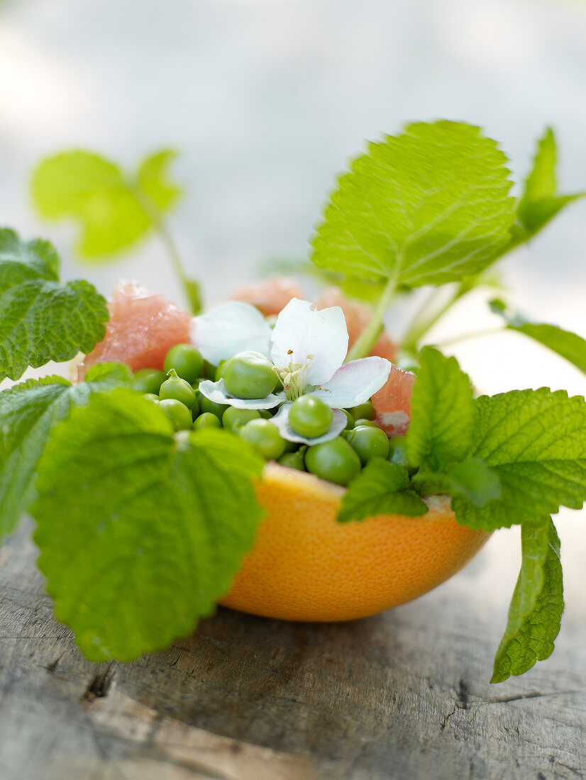 Pea and grapefruit salad in a grapefruit skin