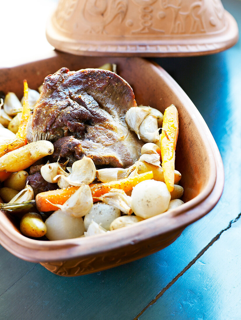 Lamb,vegetables and garlic cooked in a casserole dish