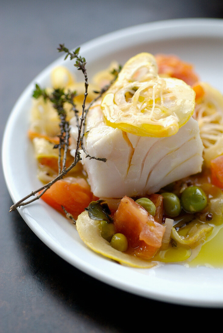 Thick piece of cod with herbs,lemon and stewed tomatoes