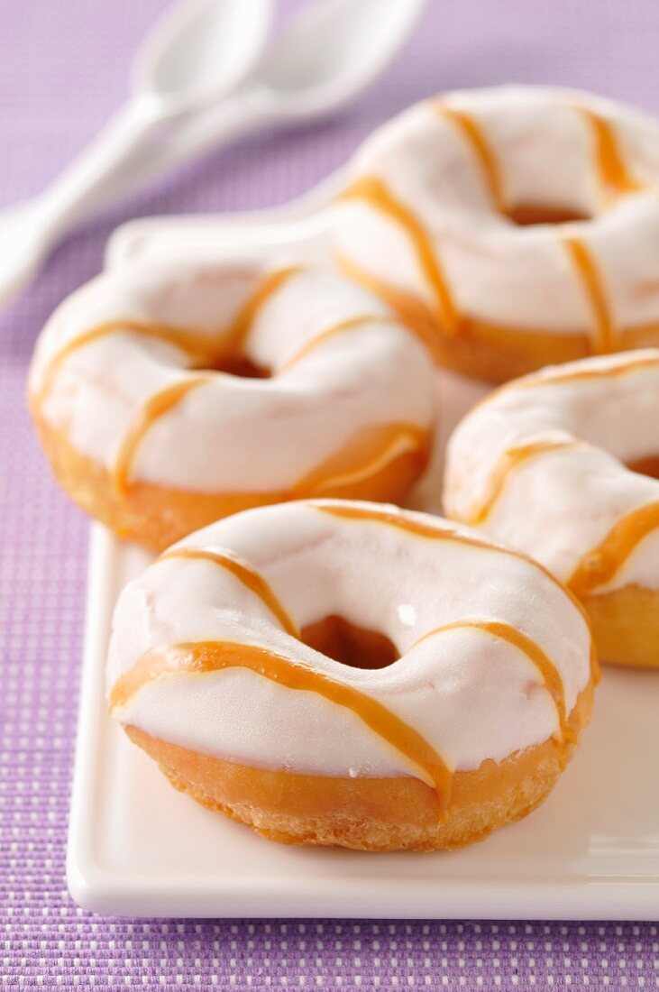 Donuts coated with icing sugar and caramel