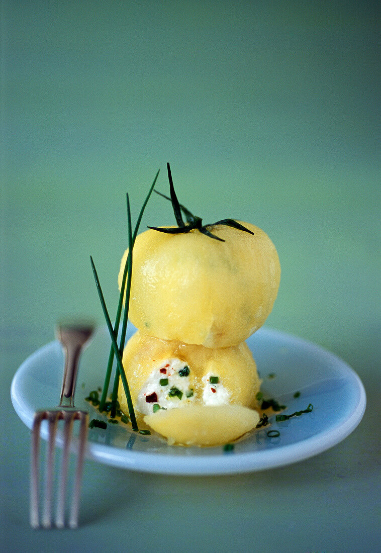 Yellow tomatoes stuffed with goat's cheese and chives